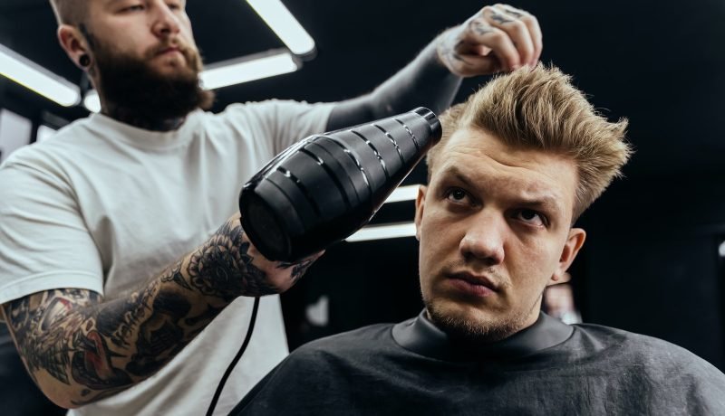 Barber Drying Male Hair In Hairdressing Salon.jpg